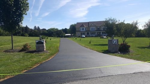 Seal Coating in Harford County Photo - Long Driveway with Large Home