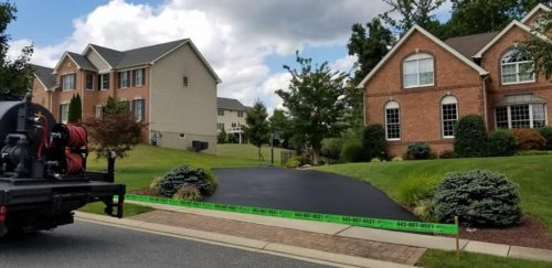 Seal Coating in Harford County Photo - Brick Colonial Home with Seal Coat and Truck in the Foreground